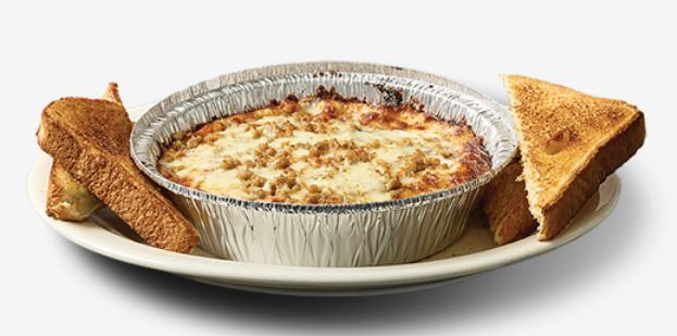 Pizza King baked spaghetti topped with melted cheese, served with garlic bread